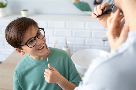 High angle smiley kid holding spoon | Free Photo