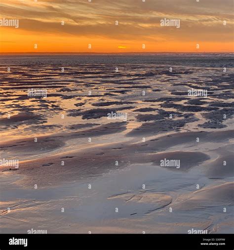 A November sunset view of low tide at Mayflower Beach, Dennis, Cape Cod ...