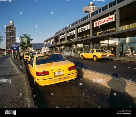 Distinctive yellow taxi cabs parked at ranks outside Terminal 2 at the ...