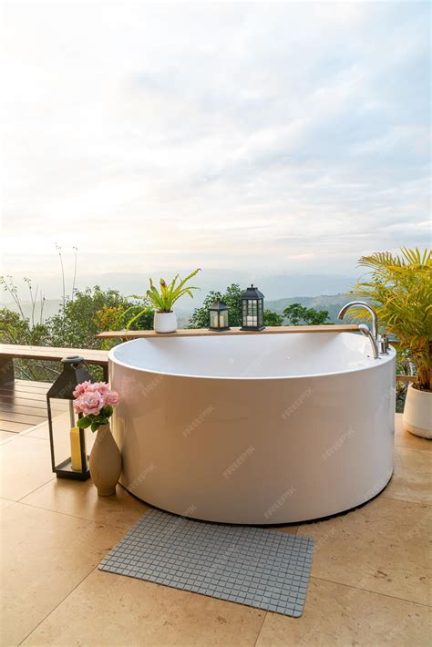 Premium Photo | Outdoor bath tub with beautiful mountain view background