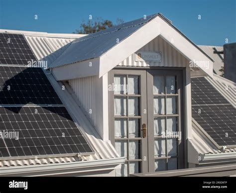 A solar panel affixed to the rooftop of a residential building, generating a sustainable source ...