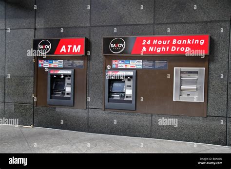 A man walks past an automated teller machine (ATM) outside Bank of America Corp. headquarters in Cha