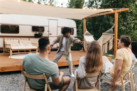 https://charades.io/wp-content/uploads/sites/9/2023/10/cool-black-guy-showing-pantomime-his-international-friends-playing-charades-game-near-rv-1024x683.jpeg