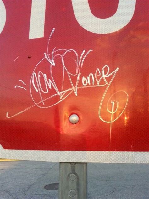 the stop sign has been vandalized with graffiti