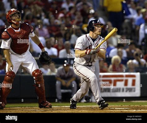 St. Louis Cardinals catcher Mike Matheny (L) and Atlanta Braves J.D. Drew watch the baseball ...