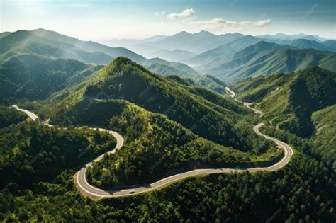 Premium Photo | Aerial view of winding road in the mountains Top view of mountain road A bird ...