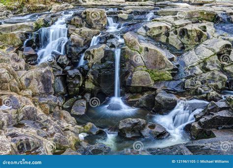 A Waterfall with Multiple Elegant Cascades Flowing Over Rocks Stock ...