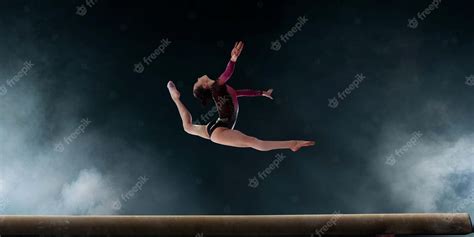 Premium Photo | Female gymnast doing a complicated trick on gymnastics ...