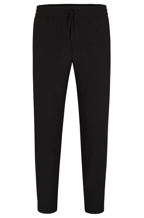 BOSS - Tapered-fit chinos in easy-iron four-way stretch fabric - Black