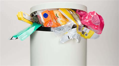 Download Overfilled White Trash Can With Lid Wallpaper | Wallpapers.com