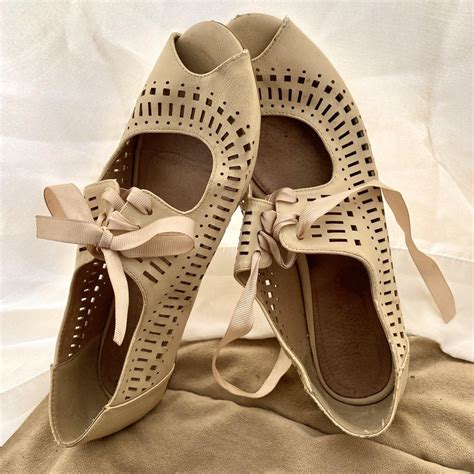 Tan ballet flats with cute ribbon tie. A little worn... - Depop