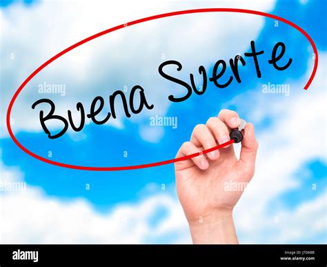Man Hand writing Buena Suerte( Good Luck in Spanish) with black marker ...