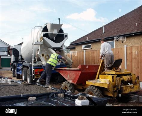 Concrete cement mixer delivery lorry truck & driver on new house ...