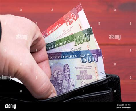 Liberian money - dollar in the black wallet Stock Photo - Alamy