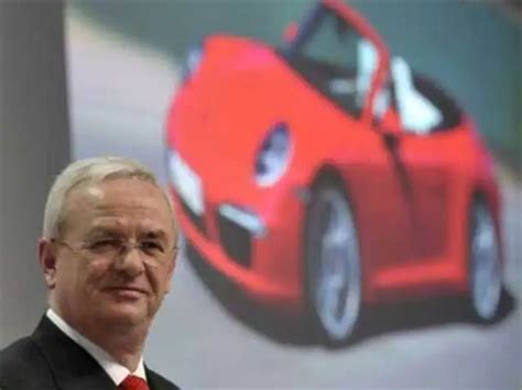 March 15, 2012 - Winterkorn poses next to a screen displaying Porsche ...