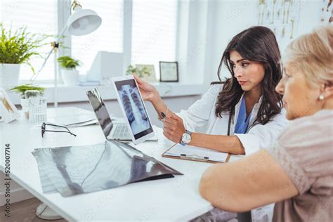 Image of a doctor and a patient reviewing a scan.