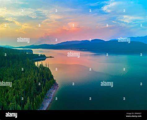 Aerial view of Hungry Horse Reservoir with forest fire in the distance ...