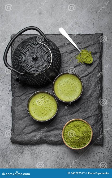 Matcha Tea Ceremony Set with Black Iron Teapot and Two Cups on Black ...
