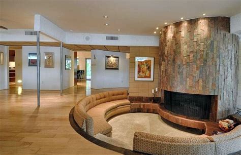 https://designingidea.com/wp-content/uploads/2016/12/curved-modern-sunken-living-room-with-circular-slate-fireplace-and-hickory-wood-floors.jpg