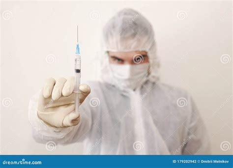 Infectious Diseases Doctor on White. Coronavirus Stop Infection. Young Male Doctor with Syringe ...