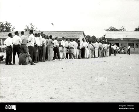 19600630 - LEOPOLDVILLE, CONGO: Men wait in line during election voting ...