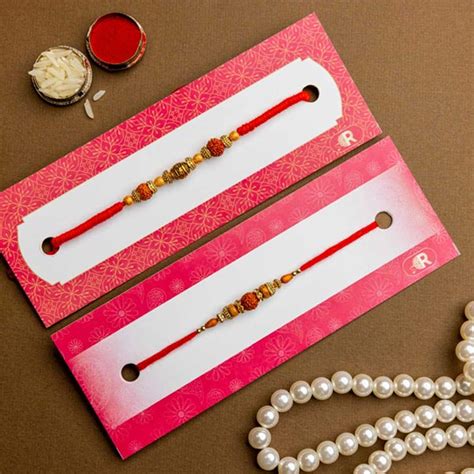Send Rudraksh Set of 2 Rakhis With Besan Laddoo & Cashews Online