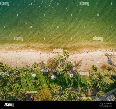 Aerial view of parasols on the lakefront beach at luxury resort along ...
