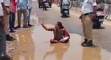 Uppal Woman sits in slush as protest against potholes