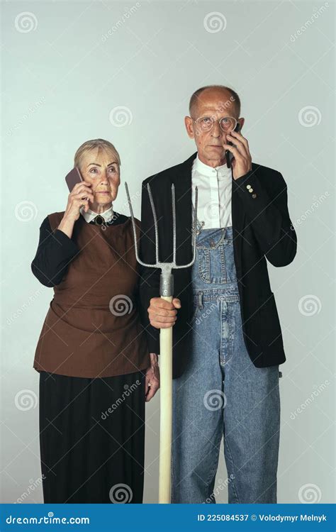 Man And Woman Painting With A Pitchfork