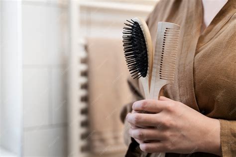 Young adult holding brush and comb | Free Photo