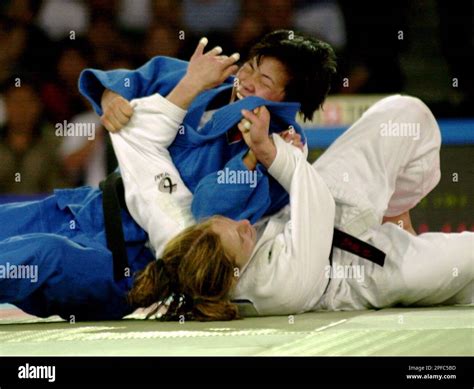 Korea's Sun Hui Kye, in blue, tries to pin down USA's Hillary Wolf, of ...