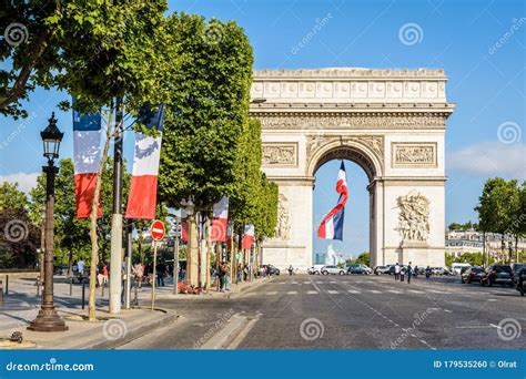 A Large French Flag Flies Under the Arc De Triomphe in Paris, France ...