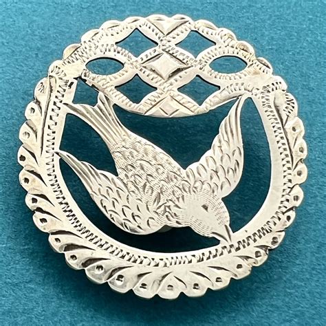 Lot Detail - Hallmarked silver button of a flying bird.