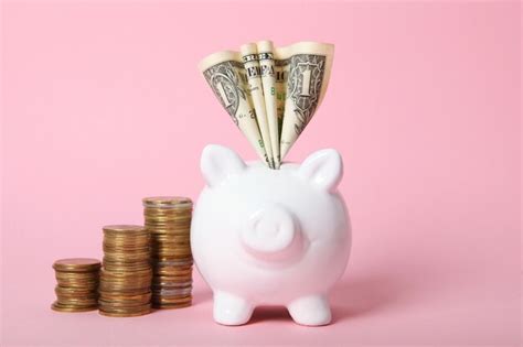 Piggy piggy bank and gold coins on a colored background | Premium Photo