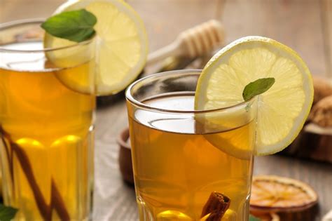 Tea with lemon and a cinnamon stick with ginger and mint in glass cups ...