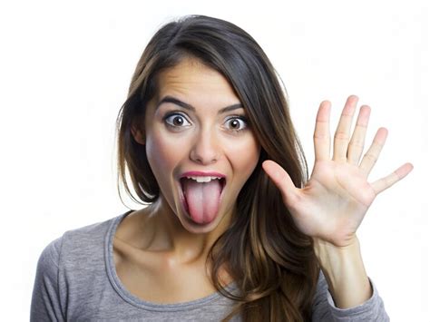 A young women making a teasing expression with her tongue out and hand ...