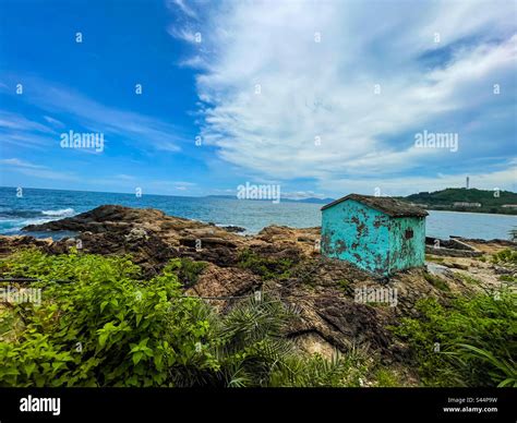 Little blue house on the rocks Stock Photo - Alamy