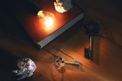 Light bulb with key on book, business success ideas concept | Premium Photo