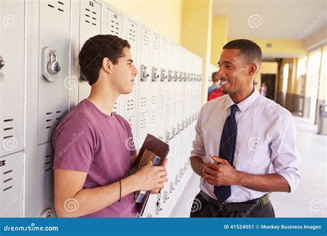 Male High School Student Talking To Teacher by Lockers Stock Image ...