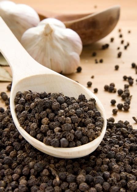 Set of garlic and pepper on wooden texture | Premium Photo