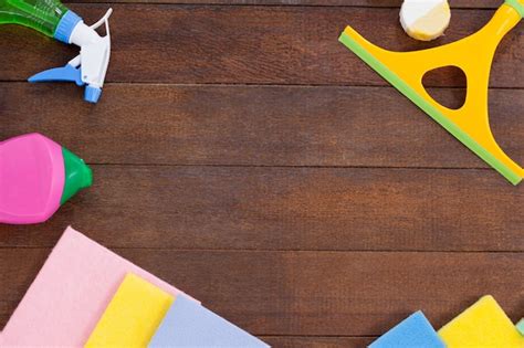 Cleaning equipments arranged on wooden floor background | Premium Photo