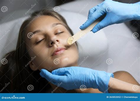Young Woman Undergoing Hair Removal Procedure on Face with Sugaring Paste in Salon Stock Photo ...