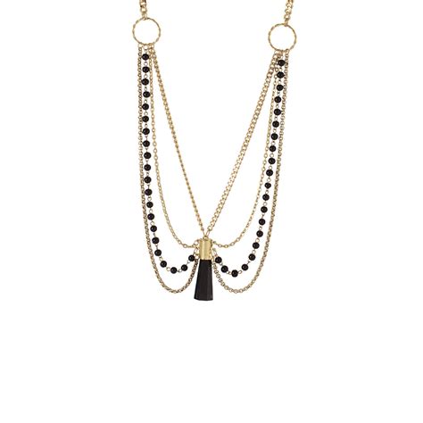 layered beaded necklace in gold tone with central drop of edgy black s ...