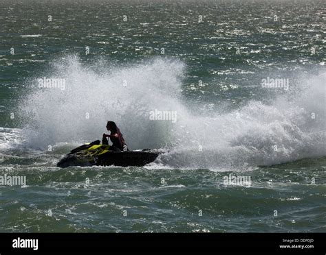 A woman performing a stunt on her Sea-Doo Spark with the words “Make Waves sales event”