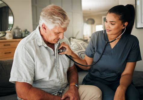 Smiling seniors with caregiver