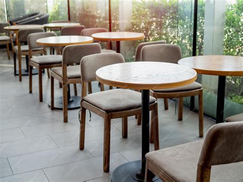 Premium Photo | Wooden tables and chairs in cafe