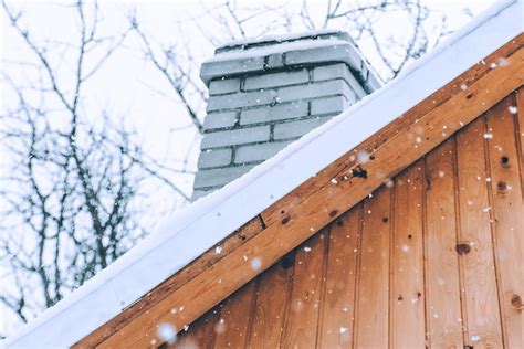 Snowfall over a wooden roof winter day | Premium Photo