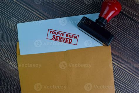 You've Been Served text on document above brown envelope. 23696255 ...