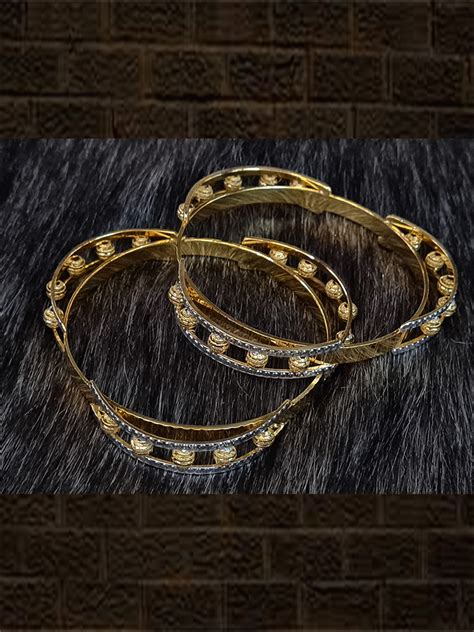 Set of two gold bangles with five gold beads design in two rhodium pla ...