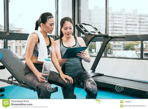 Personal Asian Fitness Instructor Is Explaining Stock Image - Image of friends, center: 110803811